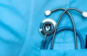 Close up of stethoscope and pen in blue medical scrubs pocket
